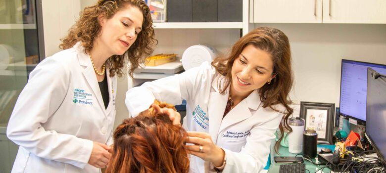 Dr. Lewis and Dr. Voelker examining Ayslyn at the Pacific Neuroscience Institute